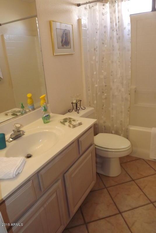 full bathroom with tile patterned floors, toilet, vanity, and shower / bath combination with curtain