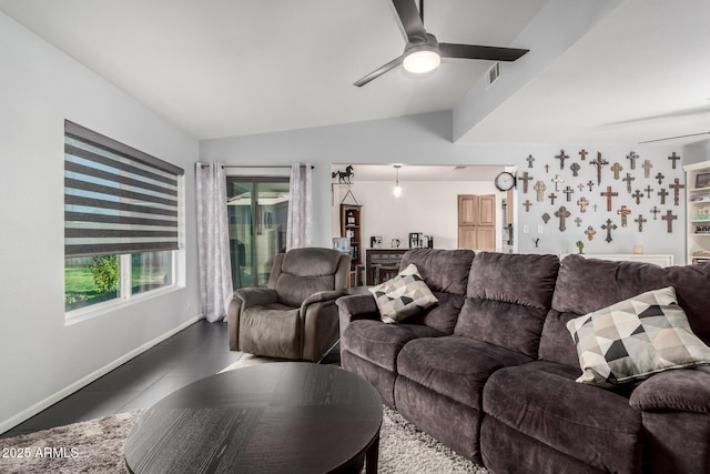 tiled living room with vaulted ceiling, visible vents, a ceiling fan, and baseboards