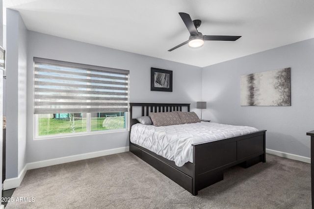 carpeted bedroom with a ceiling fan and baseboards