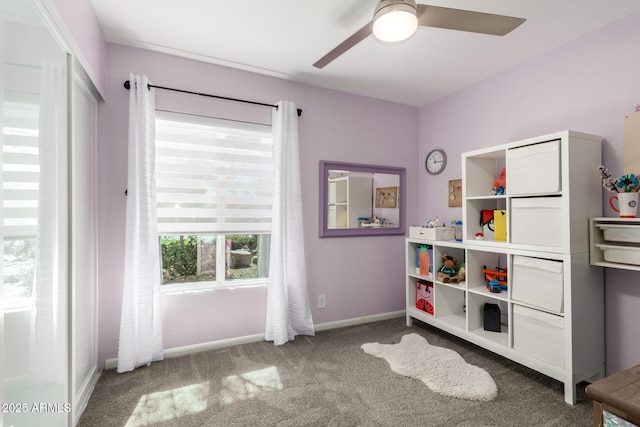 game room featuring carpet floors, ceiling fan, and baseboards