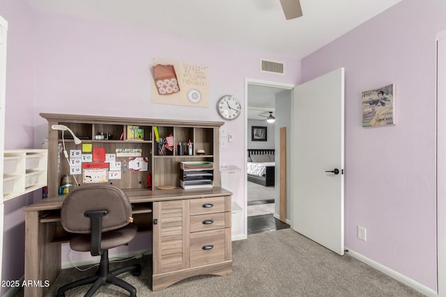 home office with carpet floors, visible vents, ceiling fan, and baseboards