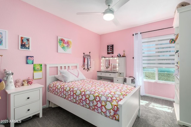 bedroom with dark colored carpet, ceiling fan, and baseboards