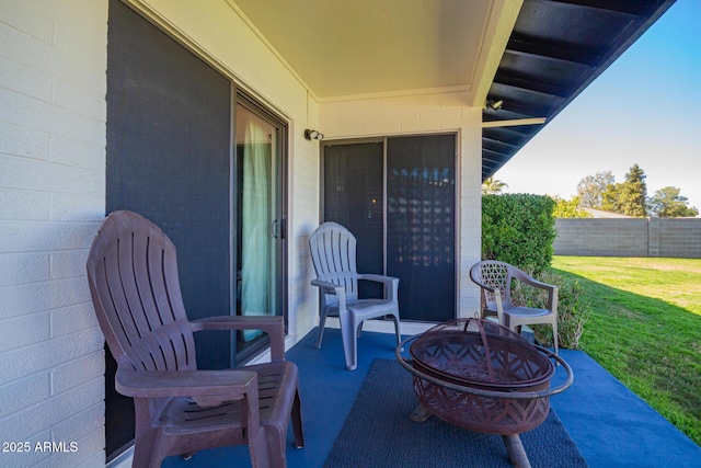 view of patio featuring fence and a fire pit