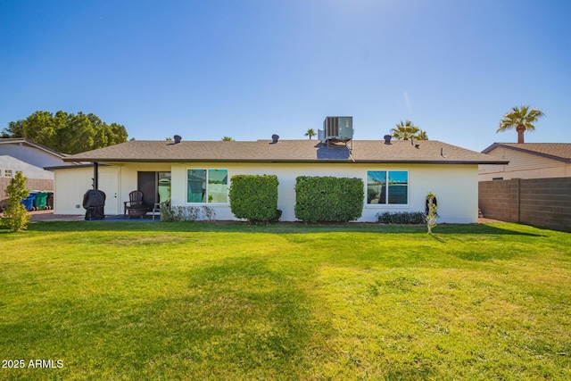 back of house featuring central air condition unit, fence, a patio, and a yard