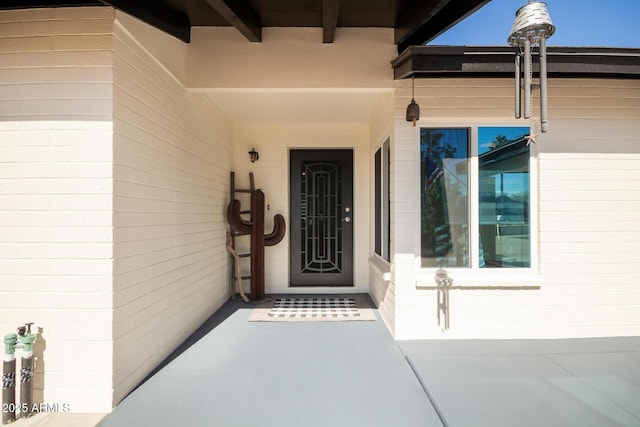 property entrance featuring brick siding