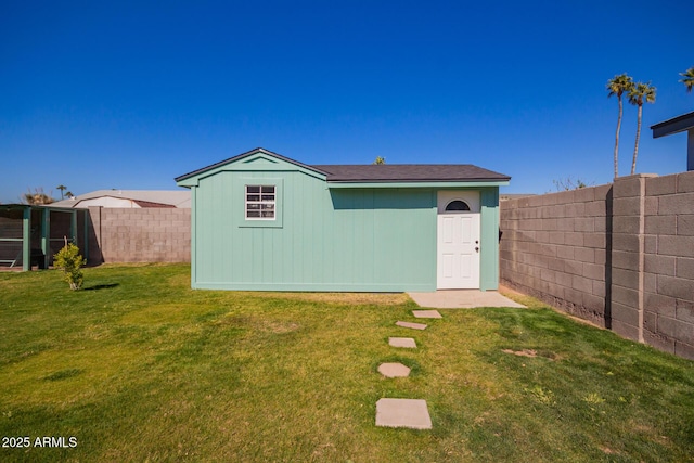 view of outdoor structure with an outbuilding and a fenced backyard