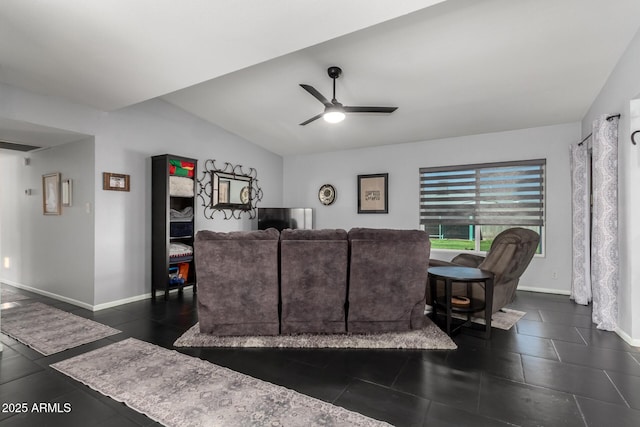 living room with vaulted ceiling, dark tile patterned floors, a ceiling fan, and baseboards