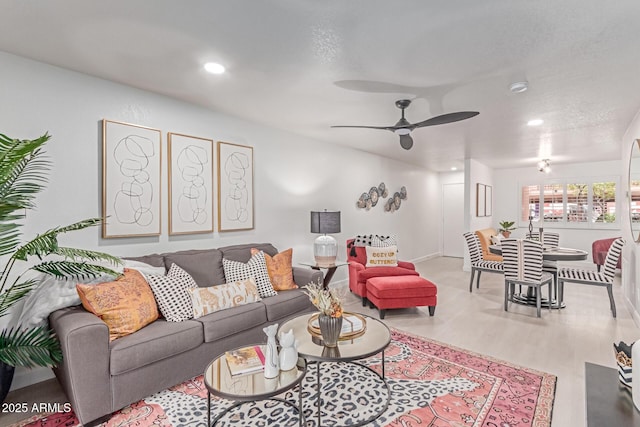 living area featuring baseboards, recessed lighting, a ceiling fan, and wood finished floors