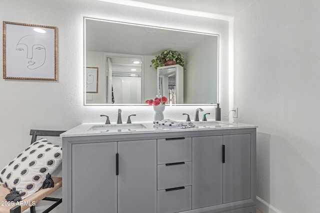 bathroom featuring a sink and double vanity