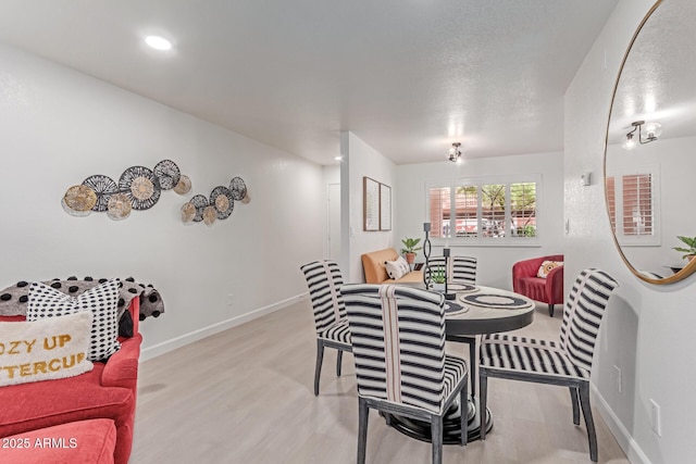 dining room featuring recessed lighting, baseboards, and wood finished floors