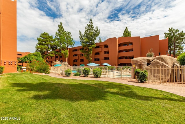 exterior space with fence and a community pool