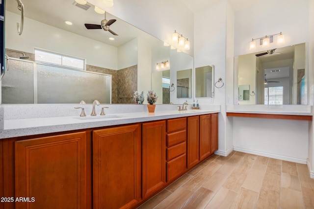 bathroom with a shower, hardwood / wood-style floors, and vanity