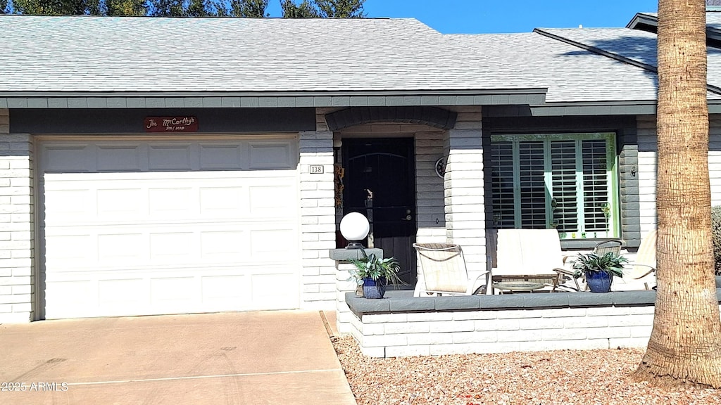 doorway to property with a garage