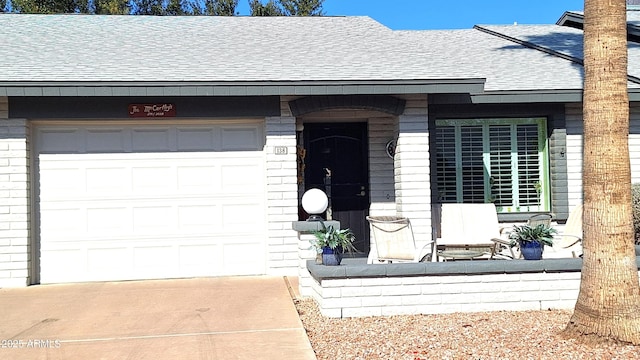 doorway to property with a garage