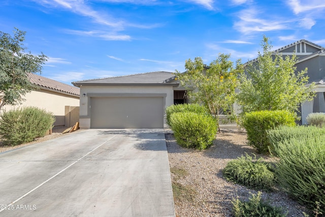 6085 E Athena Rd, Florence, AZ 85132 - view of front of home featuring stucco siding, a garage, driveway, and a tile roof