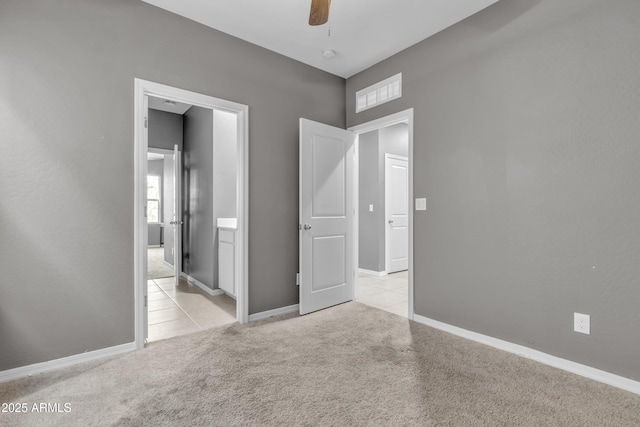 6085 E Athena Rd, Florence, AZ 85132 - unfurnished bedroom featuring carpet flooring, ensuite bathroom, tile patterned floors, and a ceiling fan