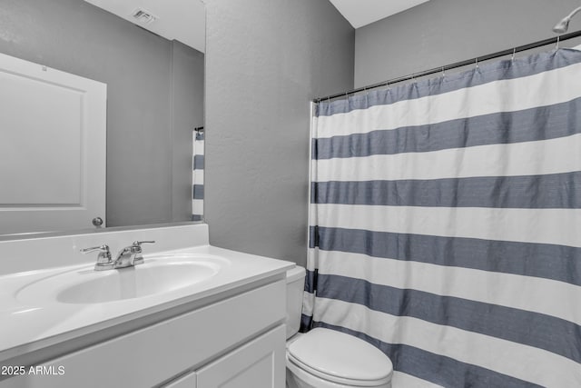 6085 E Athena Rd, Florence, AZ 85132 - bathroom with vanity, a textured wall, and a shower with curtain