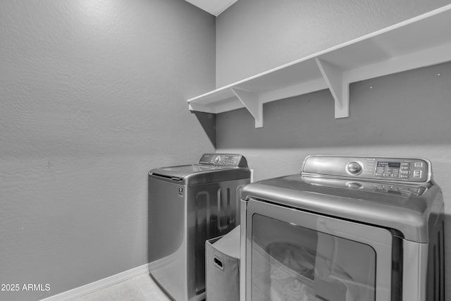6085 E Athena Rd, Florence, AZ 85132 - laundry area featuring washing machine and clothes dryer, a textured wall, and tile patterned flooring