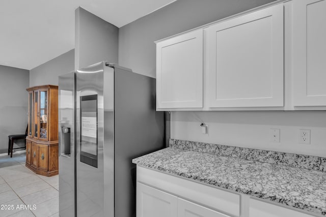 6085 E Athena Rd, Florence, AZ 85132 - kitchen featuring stainless steel fridge with ice dispenser, light stone countertops, white cabinets, and light tile patterned flooring