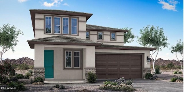 prairie-style home featuring a garage