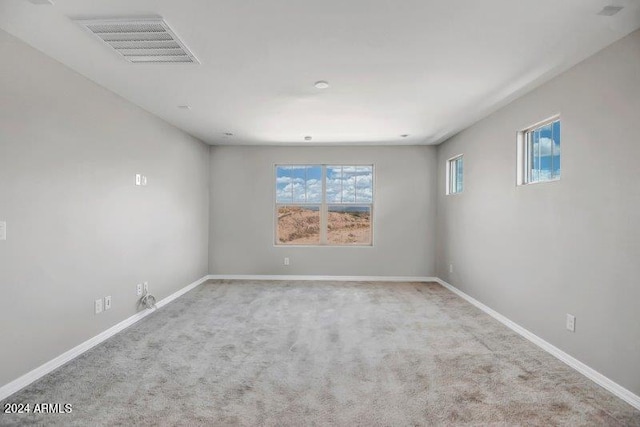 unfurnished room with light carpet