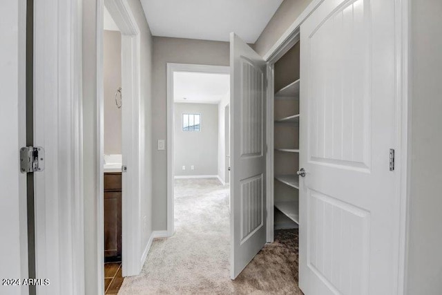 hallway with light colored carpet