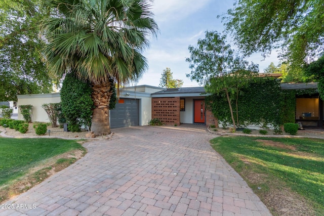 301 W Royal Palm Rd, Phoenix, AZ 85021 - view of front of property with stucco siding, decorative driveway, a garage, and a front lawn