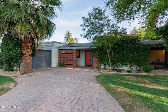 301 W Royal Palm Rd, Phoenix, AZ 85021 - view of front of home with decorative driveway, stucco siding, a garage, and a front lawn
