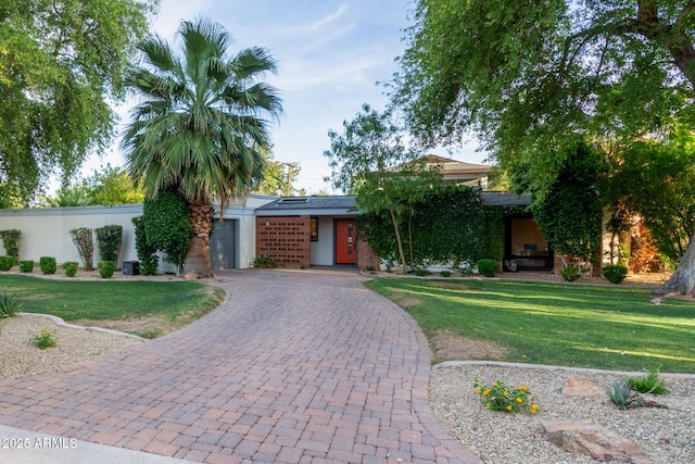 301 W Royal Palm Rd, Phoenix, AZ 85021 - view of front facade with decorative driveway, a front lawn, a garage, and stucco siding