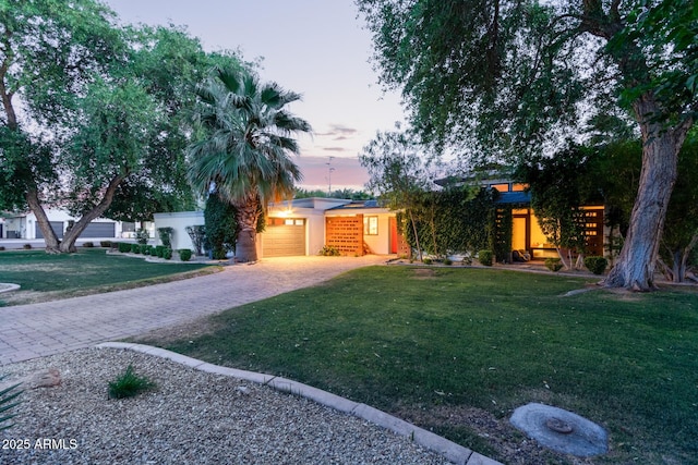 301 W Royal Palm Rd, Phoenix, AZ 85021 - view of front of property with decorative driveway, an attached garage, a lawn, and stucco siding