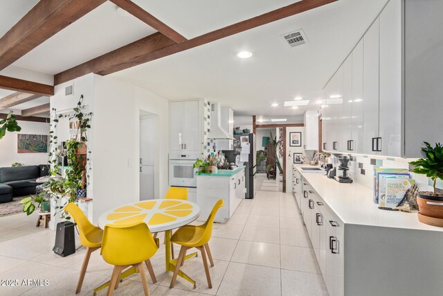 301 W Royal Palm Rd, Phoenix, AZ 85021 - dining space featuring beam ceiling, light tile patterned flooring, and recessed lighting