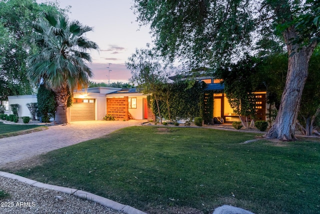 301 W Royal Palm Rd, Phoenix, AZ 85021 - view of front facade with decorative driveway, a yard, an attached garage, and stucco siding