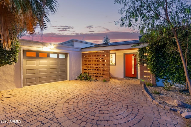 301 W Royal Palm Rd, Phoenix, AZ 85021 - view of front of home featuring a garage, stucco siding, and driveway