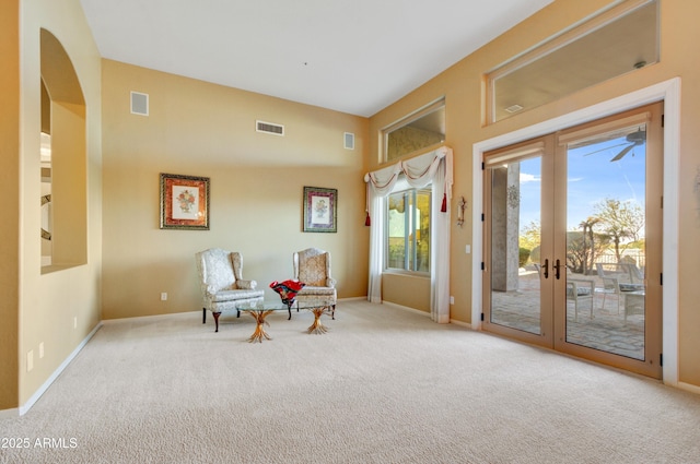 sitting room with visible vents, french doors, light carpet, and baseboards