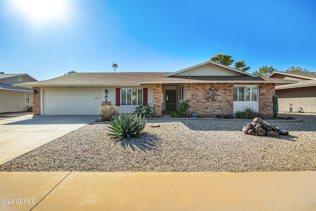 ranch-style house featuring a porch and a garage