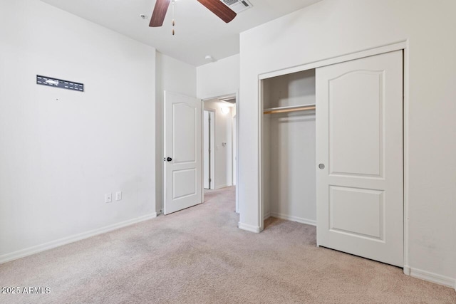 unfurnished bedroom with a closet, light carpet, visible vents, and baseboards