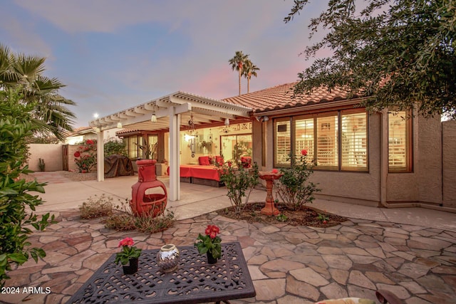 patio terrace at dusk with a pergola