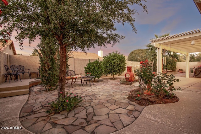 view of patio terrace at dusk