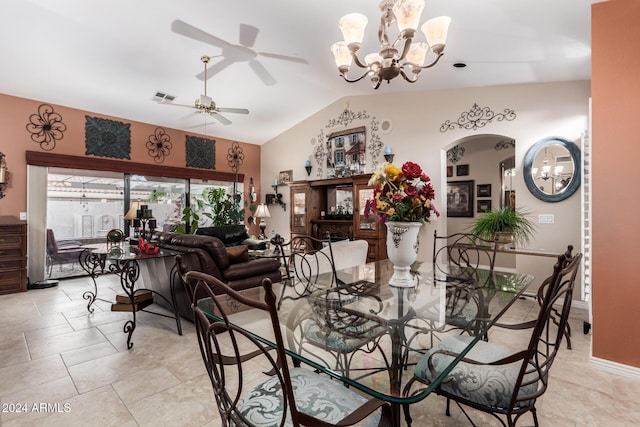 dining space featuring ceiling fan with notable chandelier and lofted ceiling