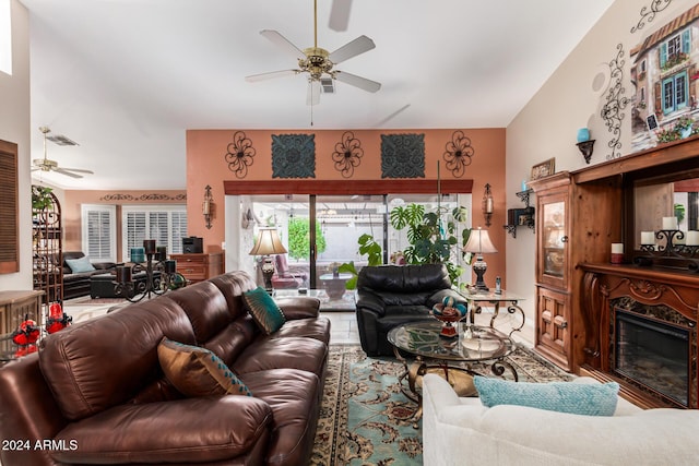 living room with ceiling fan and a premium fireplace