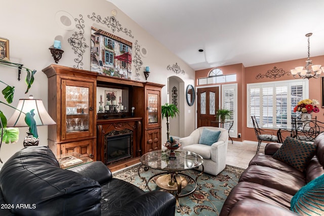 tiled living room featuring a chandelier and vaulted ceiling