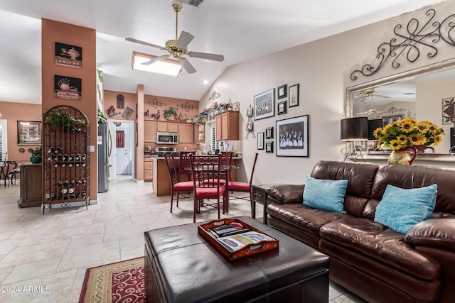 living room featuring ceiling fan and vaulted ceiling