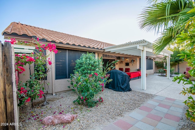 view of front facade featuring a pergola and a patio