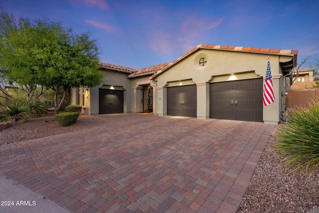 mediterranean / spanish house with a garage