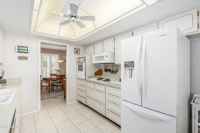 kitchen with white cabinets, decorative light fixtures, white appliances, and light tile patterned floors