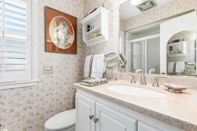 bathroom with vanity, an enclosed shower, and toilet