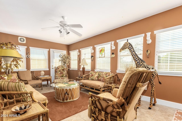 living room featuring ceiling fan, light tile patterned flooring, and a healthy amount of sunlight