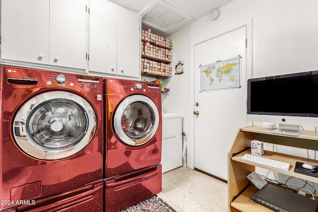 laundry area with cabinets and washing machine and clothes dryer