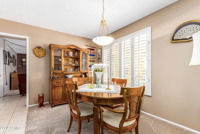 dining room with light tile patterned floors and a textured ceiling