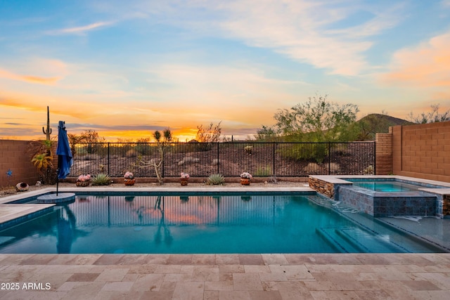 view of swimming pool with a pool with connected hot tub and a fenced backyard